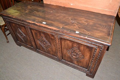 Lot 574 - Reproduction oak blanket chest with carved panel