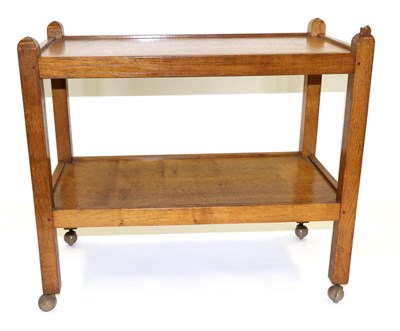 Lot 596 - A Robert  "Mouseman " Thompson Oak Tea Trolley, with two tiers both with raised sides joined by...