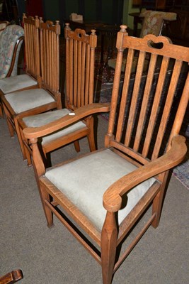 Lot 605 - A set of three oak Arts & Crafts chairs and carver, with vertical slat backs and upholstered seats