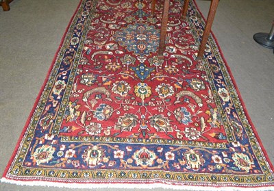 Lot 611 - Kashgai rug, South West Persia, the blood red field of palmettes and vines around a dove grey...