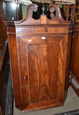 Lot 624 - A George III mahogany hanging corner cupboard