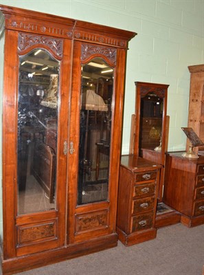 Lot 637 - A walnut two piece bedroom suite comprising a wardrobe and dressing table