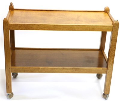 Lot 603 - A Robert  "Mouseman " Thompson Oak Tea Trolley, with two tiers both with raised sides joined by...