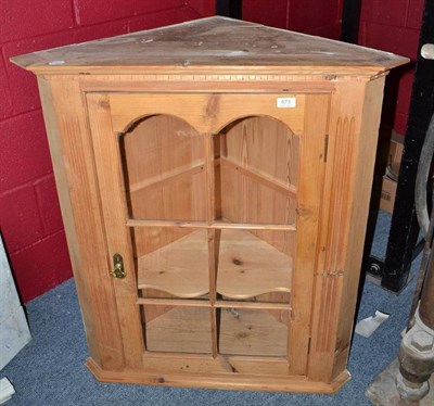 Lot 673 - A glazed pine corner cabinet