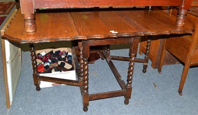 Lot 679 - An oak drop-leaf table with barley-twist legs, satinwood three-height chest of drawers and another