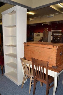 Lot 699 - Pine blanket box, pine table, three kitchen chairs and an open shelf unit