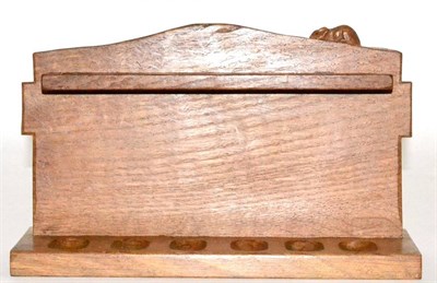 Lot 610 - A Robert Mouseman Thompson Oak Pipe Rack, with six holders, shaped square back and carved mouse...