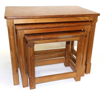 Lot 611 - A Robert  "Mouseman " Thompson Nest of Three Oak Tables, on four octagonal legs, each with...