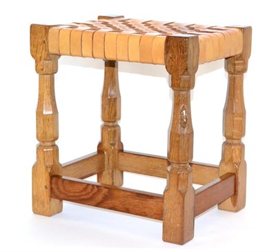 Lot 620 - A Robert  "Mouseman " Thompson Oak Stool, with lattice leather top, on four octagonal legs...