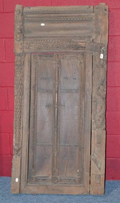 Lot 906 - A pair of teak doors in original frame with fine decoration