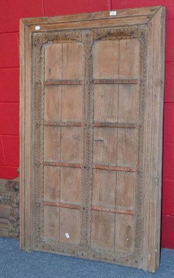 Lot 908 - A pair of 17th century Jaisalmer, Rajasthan India teak doors, banded with iron work in a carved and