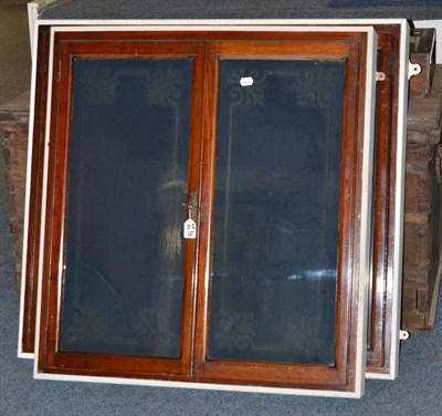 Lot 913 - A pair of Edwardian mahogany and glass hanging cupboards, decorated with ribbon work; and a counter