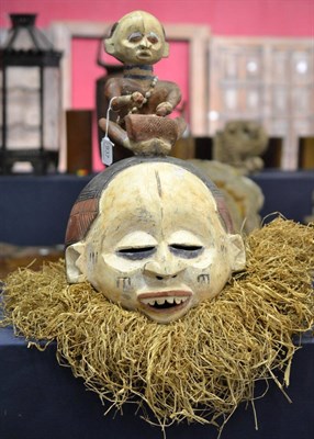 Lot 937 - An early 20th century ceremonial 'Suku' helmet mask from Congo, with original paintwork, raffia...