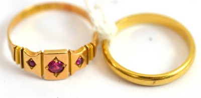 Lot 23 - An 18ct gold band ring and a 15ct gold ruby ring (2)