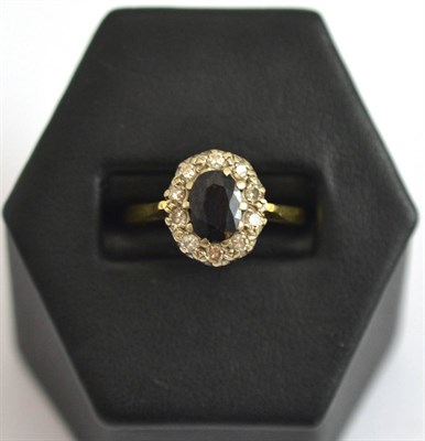 Lot 24 - An 18ct gold, sapphire and diamond cluster ring
