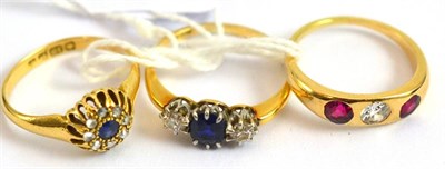 Lot 43 - An 18ct gold sapphire and diamond cluster ring, a diamond and red stone three stone ring,...