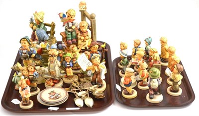 Lot 65 - Collection of Hummel (Goebel) figures on two trays and two racks of miniature Hummel plates