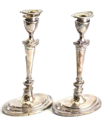 Lot 79 - A pair of Britannia standard silver Neo Classical style candlesticks, Hendeles & Co, London...