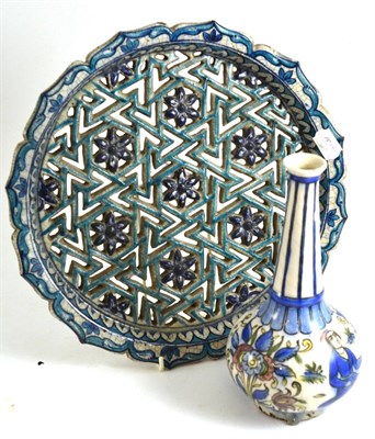 Lot 92 - A Kajar faience bottle vase, 24cm high and a Middle Eastern faience pierced dish, diameter 34cm (2)