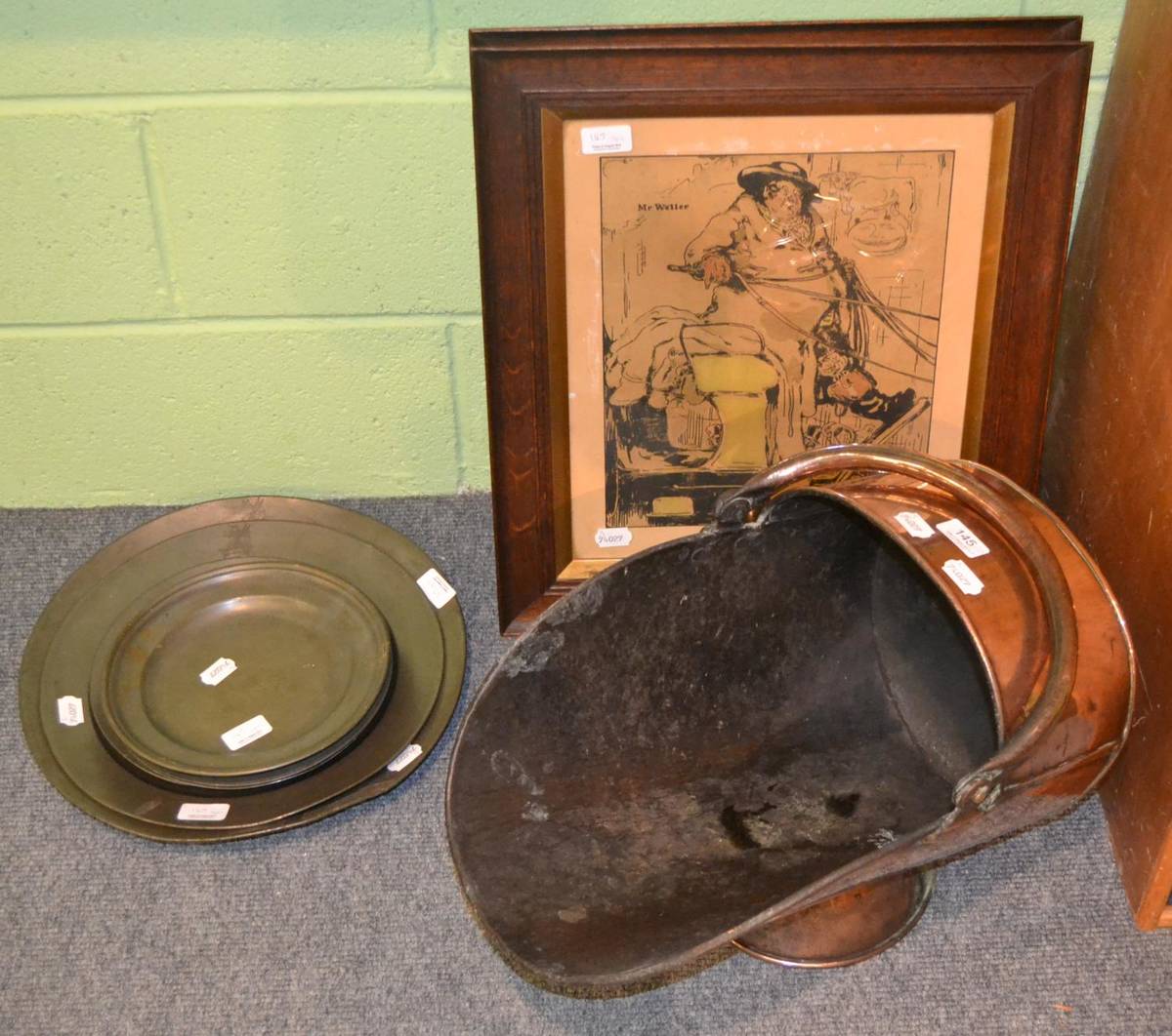 Lot 145 - Three graduating crested pewter dishes, four others, a copper helmet coal scuttle and a pair of oak