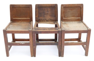 Lot 650 - Three Robert  "Mouseman " Thompson Oak Panel Back Chairs, solid seats, joined by rails, each...