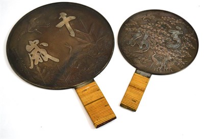 Lot 257 - A Japanese bronze hand mirror, polished and silvered to one side, the reverse cast with cranes,...