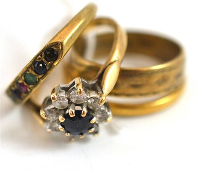 Lot 268 - A 22ct gold band ring and four dress rings