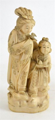 Lot 339 - A Japanese Meji period one piece carved ivory okimono of two young children, one holding two...