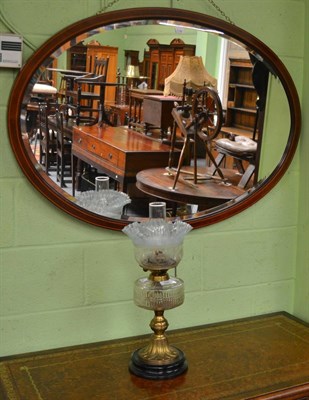 Lot 396 - Mirror and an oil lamp