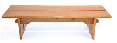 Lot 671 - A Pair of Acorn Industries Oak 6ft Benches, on two shaped supports, joined by a rail, with recessed