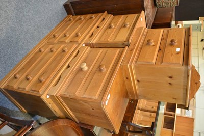 Lot 1052 - A narrow pie chest with a bank of six drawers, a pair of pine side tables with two drawers and...