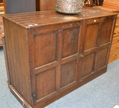 Lot 1054 - Panelled oak cupboard