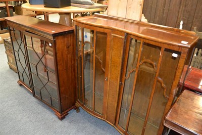 Lot 1065 - A 1920s/30s walnut display cabinet, mahogany display cabinet and a mahogany table (3)