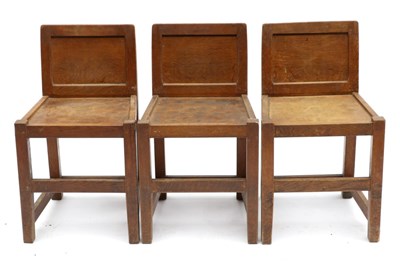 Lot 677 - Three Acorn Industries Oak Panel Back Chairs, solid seats, joined by rails, each with recessed...