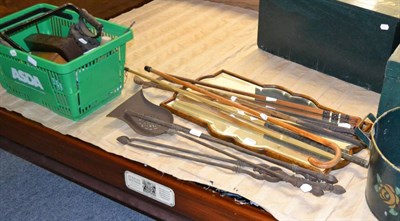 Lot 1079 - A mirror, a quantity of walking sticks, golf clubs, tools etc