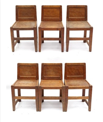 Lot 678 - A Set of Six Thomas  "Gnomeman " Whittaker Oak Panel Back Chairs, solid seats, joined by rails,...