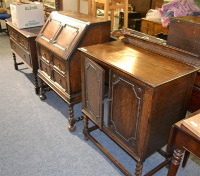 Lot 1085 - An oak bureau, oak dressing table and an oak cupboard