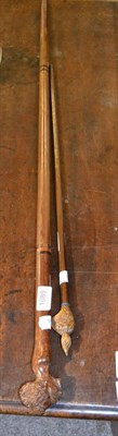 Lot 1089 - An African chief's staff with carved head pommel and a swagger stick with pommel carved as a...