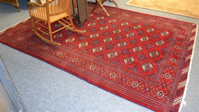 Lot 1151 - Turkman carpet, North Persia, the crimson field with columns of diamond guls enclosed by...