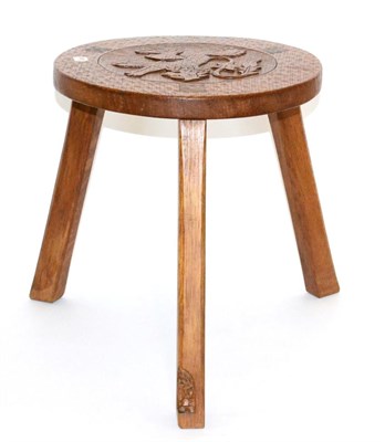 Lot 686 - A Thomas  "Gnomeman " Whittaker Oak Stool, the adzed circular seat carved with a lion rampant,...