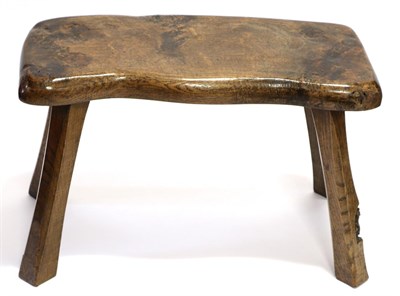 Lot 688 - A Thomas  "Gnomeman " Whittaker Oak Stool, the shaped seat on four splayed chamfered square section