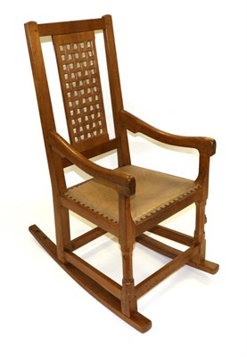 Lot 691 - A Peter  "Rabbitman " Heap Oak Rocking Chair, with lattice panel back and shaped arms, with...