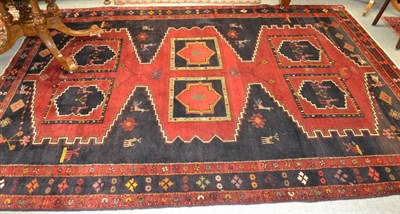 Lot 1237 - Kurdish carpet, West Persia, the deep indigo field with three stepped linked medallions...