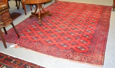 Lot 1238 - Turkmen rug, North Afghanistan, the blood red field with rows of quartered guls enclosed by...