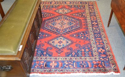 Lot 1243 - Viss rug, West Persia, the field with three salmon pink linked and hooked medallions enclosed...