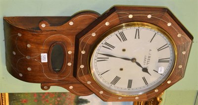 Lot 1252 - An inlaid rosewood drop dial wall clock by A J Bell, Ltd, Leeds, with octagonal case, circular...