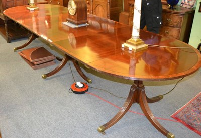 Lot 1307 - A good reproduction Regency style mahogany three pedestal dining table with two extra leaves