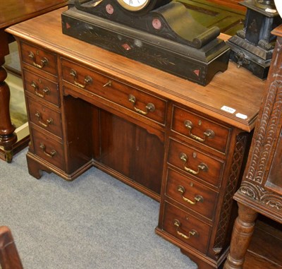 Lot 1309 - A Chippendale style walnut kneehole desk