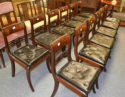 Lot 1314 - A set of twelve reproduction mahogany Regency style bar back dining chairs with black leather...