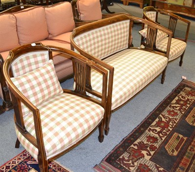 Lot 1316 - An Edwardian three piece suite comprising two tub chairs and a two seater settee, each mahogany...